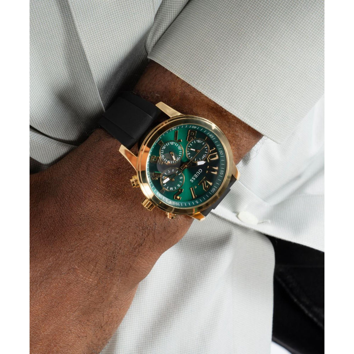Men's green dial gold-tone watch on wrist with black silicone strap