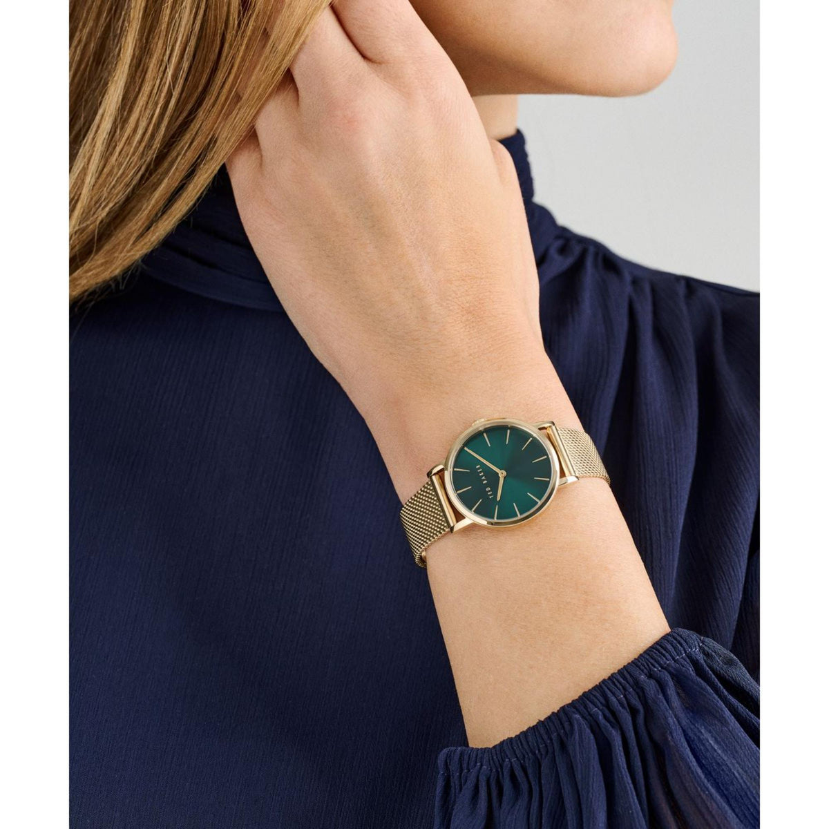 Ted Baker ladies watch with green dial and gold-tone mesh bracelet on wrist