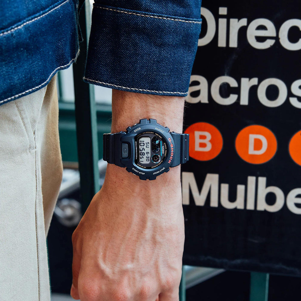 Men's black G-SHOCK digital resin watch on wrist with LCD time display
