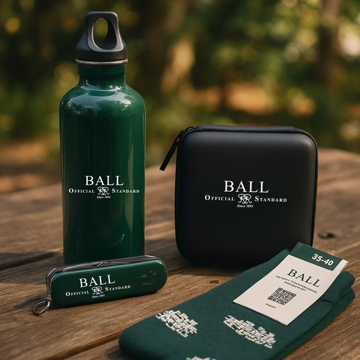 BALL gift bundle featuring a green bottle, black zip bag, and green socks with labels