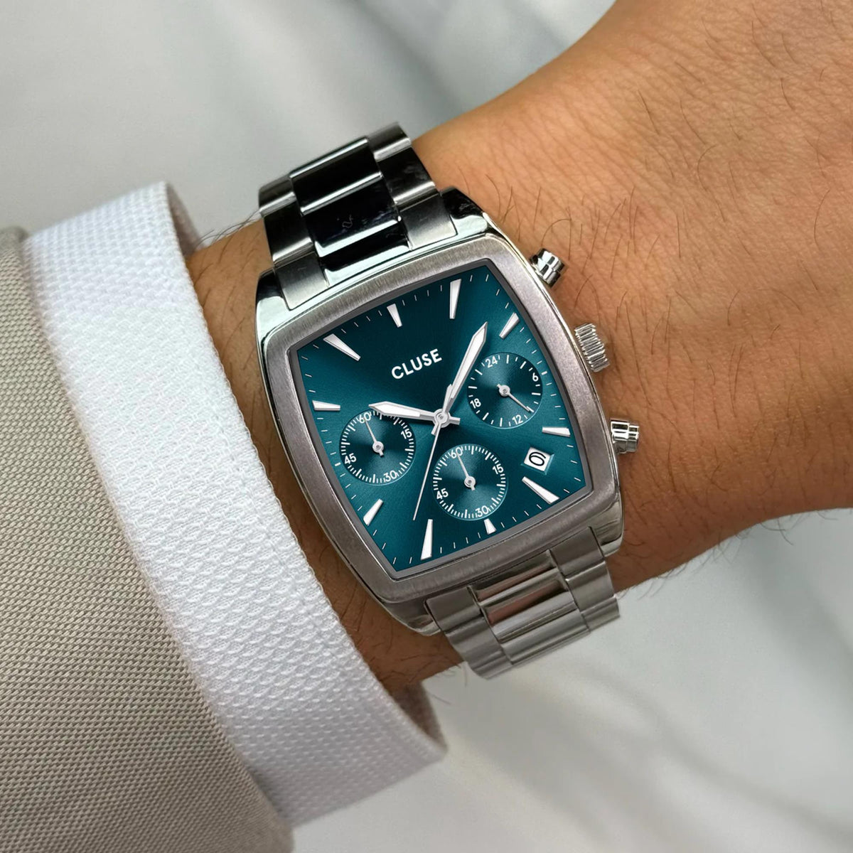 CLUSE men’s chronograph watch with rectangular steel case, blue dial, and metal bracelet