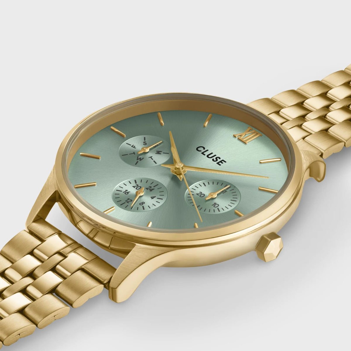 CLUSE Minuit watch close-up, green dial chronograph and gold-tone steel bracelet