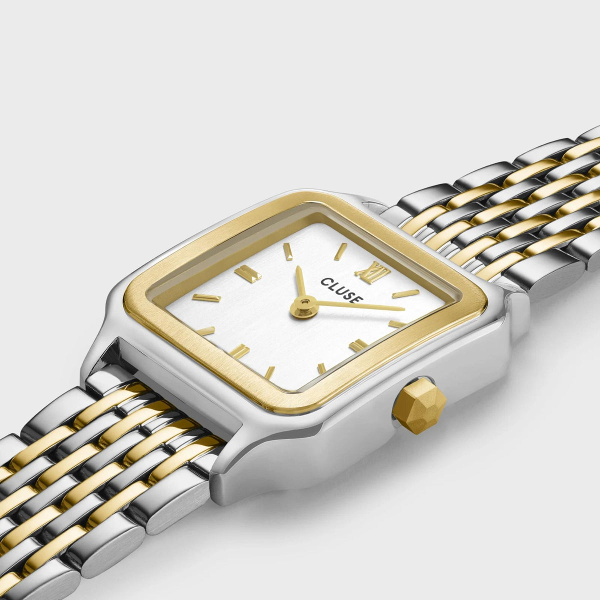 Close-up square watch face with gold dial and two-tone linked metal strap