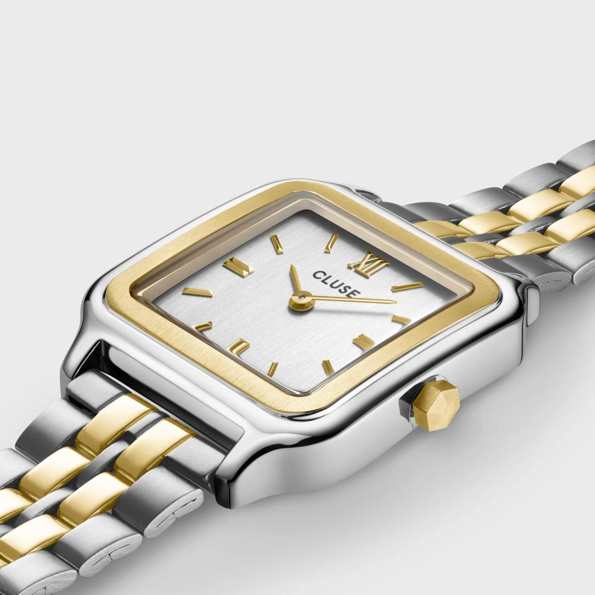 Two-tone square watch case with white dial and gold bezel, linked steel bracelet