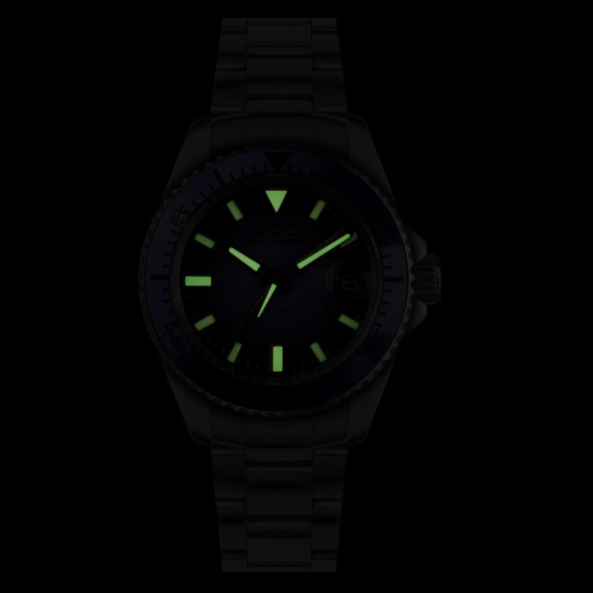 Men's black watch with purple bezel and green lume on the dark dial at night
