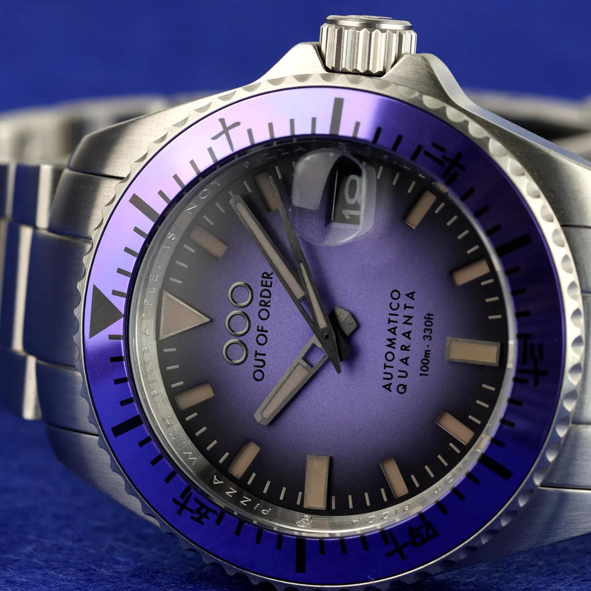Men's automatic steel watch close-up with purple dial, purple bezel, and luminous markers