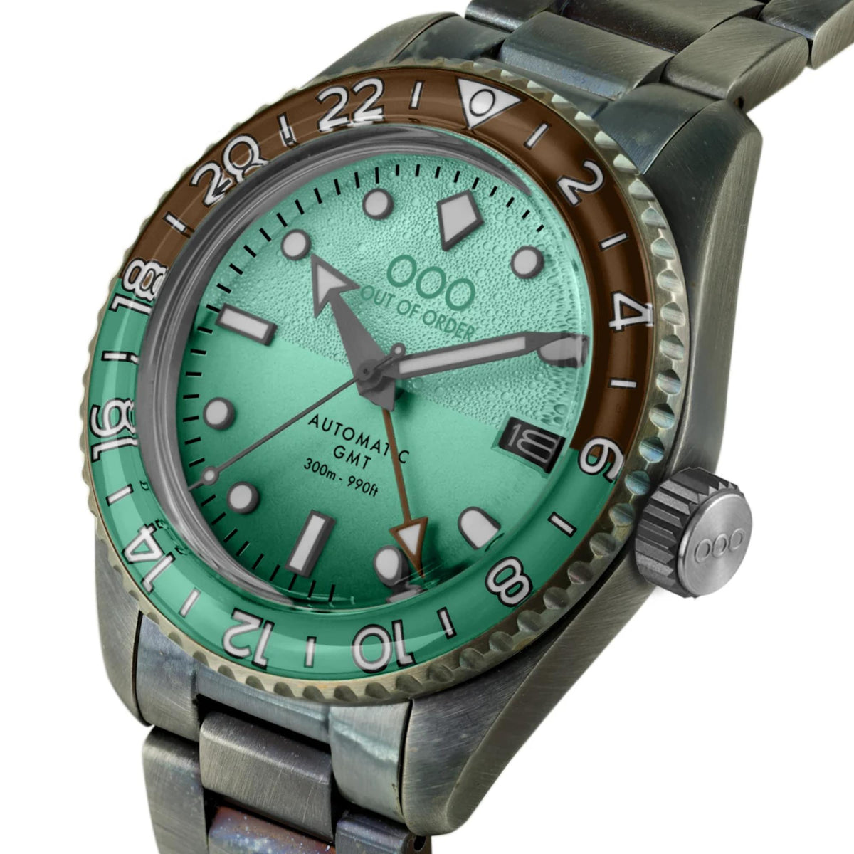 Men's automatic GMT watch close-up with mint-green dial, silver case, and metal bracelet