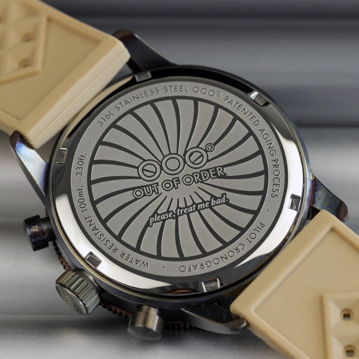 Men's watch caseback with engraved OOO starburst logo, black bezel, tan strap