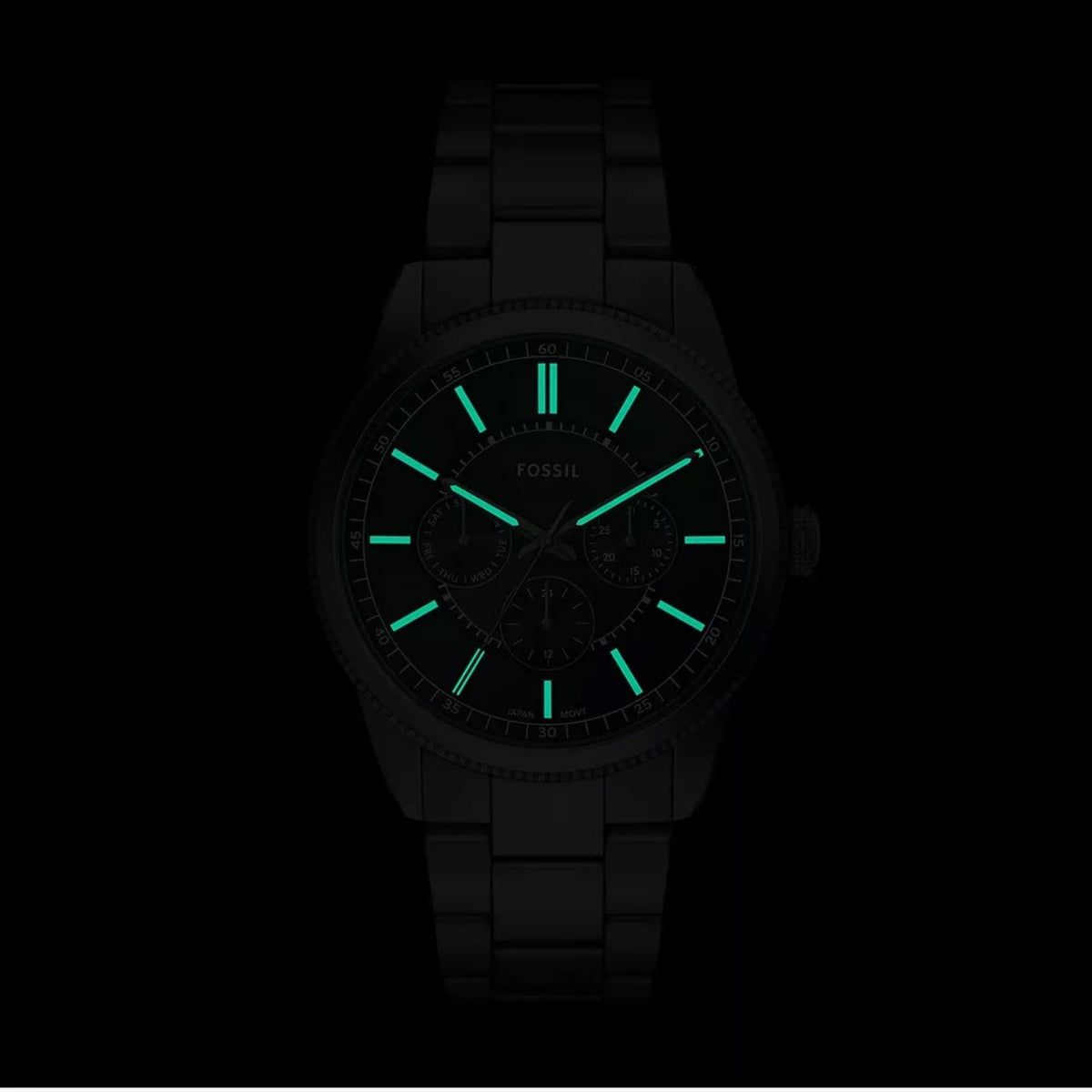 Luminous dial shot of the Fossil Pearson FS6136 watch showing glowing hands and hour markers against a dark background