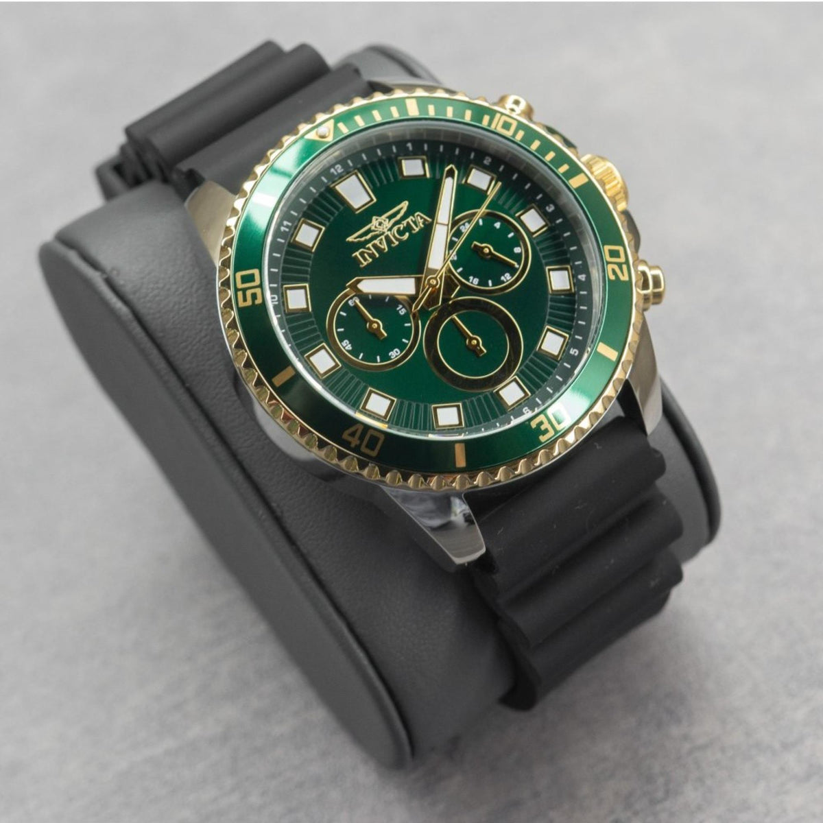 Men's Invicta dive watch with green dial and gold-tone case on black silicone strap