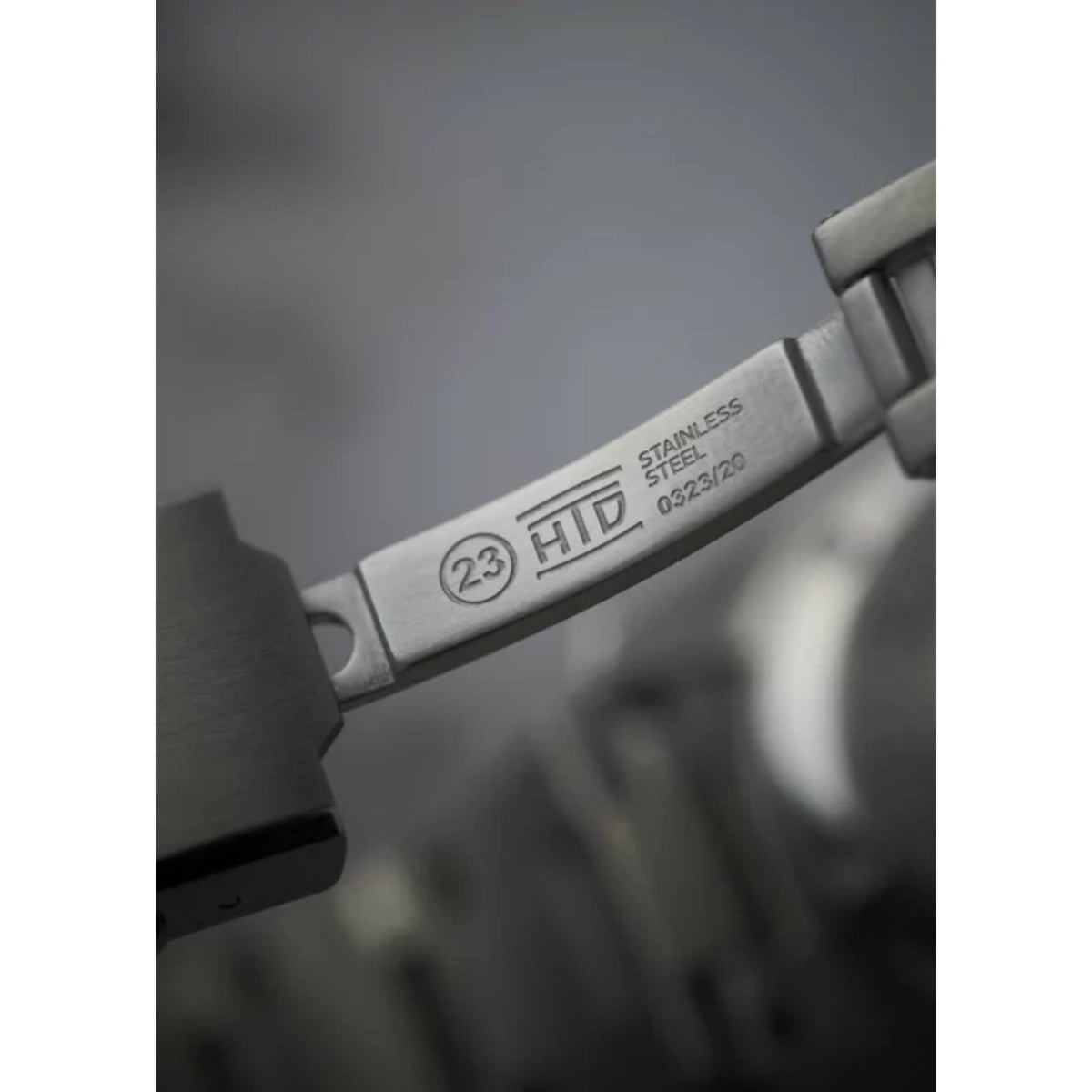 Stainless steel watch bracelet clasp with HTD branding and model markings