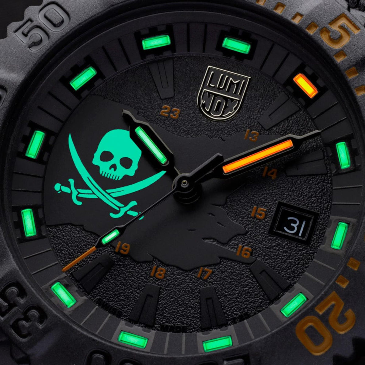 Close-up of black skull dial with green luminous markers and orange highlight hands