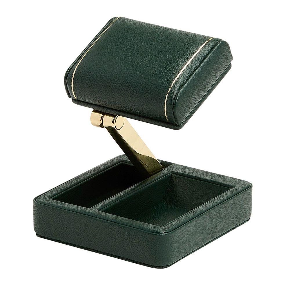 Green single watch travel stand with open base and brass-tone support arm.