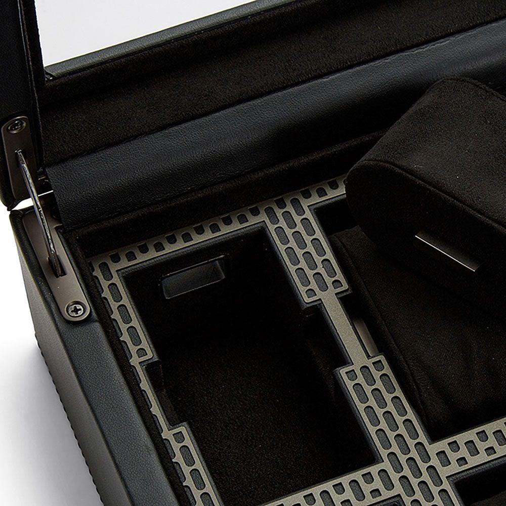 Open watch box base with black foam lining and gray perforated dividers