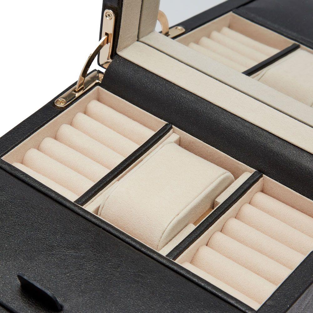Black watch winder interior with multiple light-beige watch holders and padded trays.
