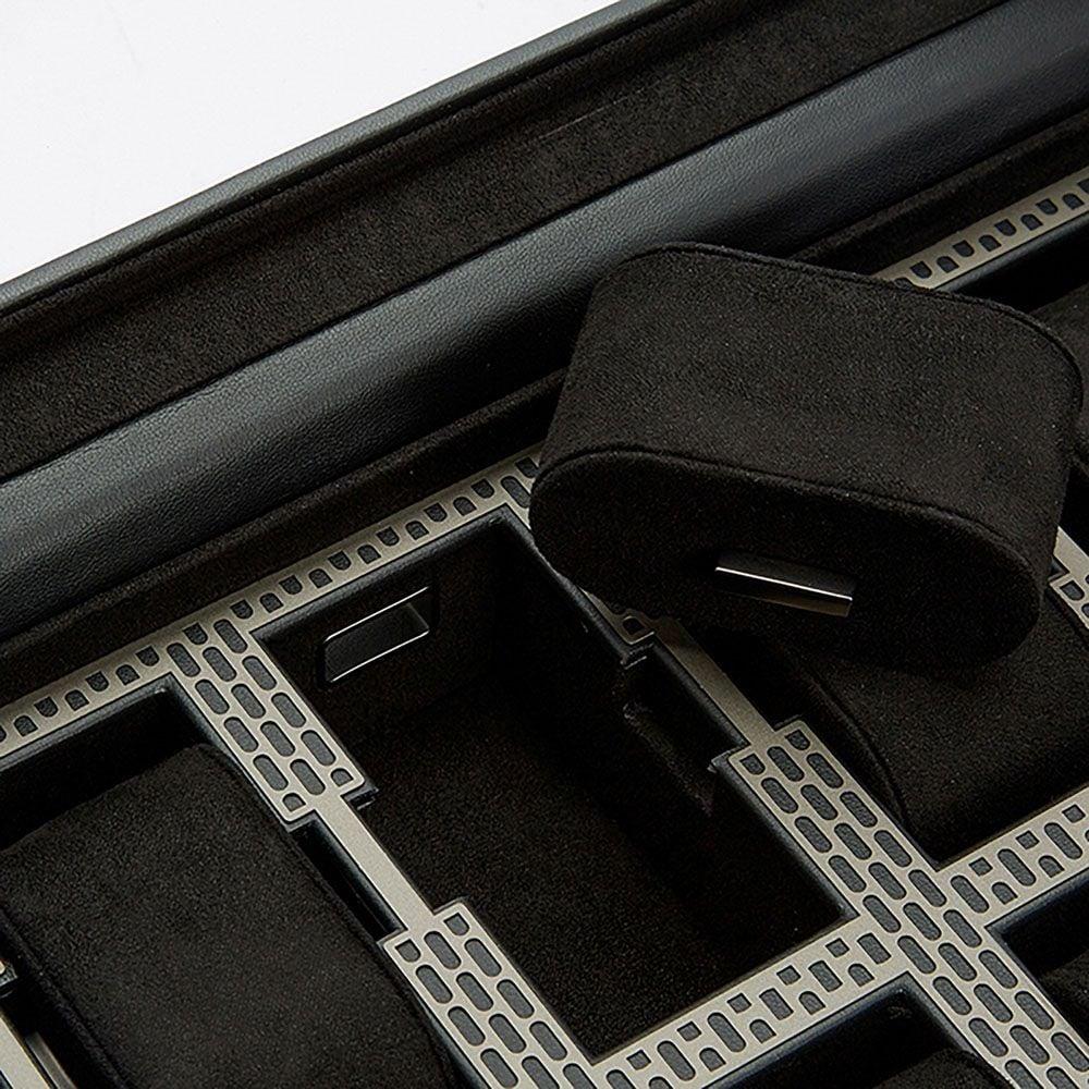 Close-up of black foam watch holders in metal grid rows