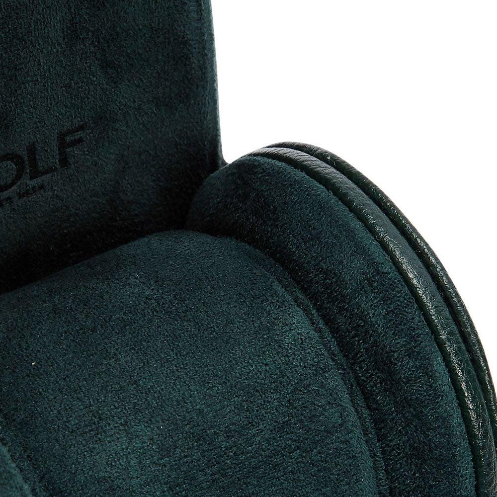 Close-up of green suede watch roll interior with stitching and embossed logo