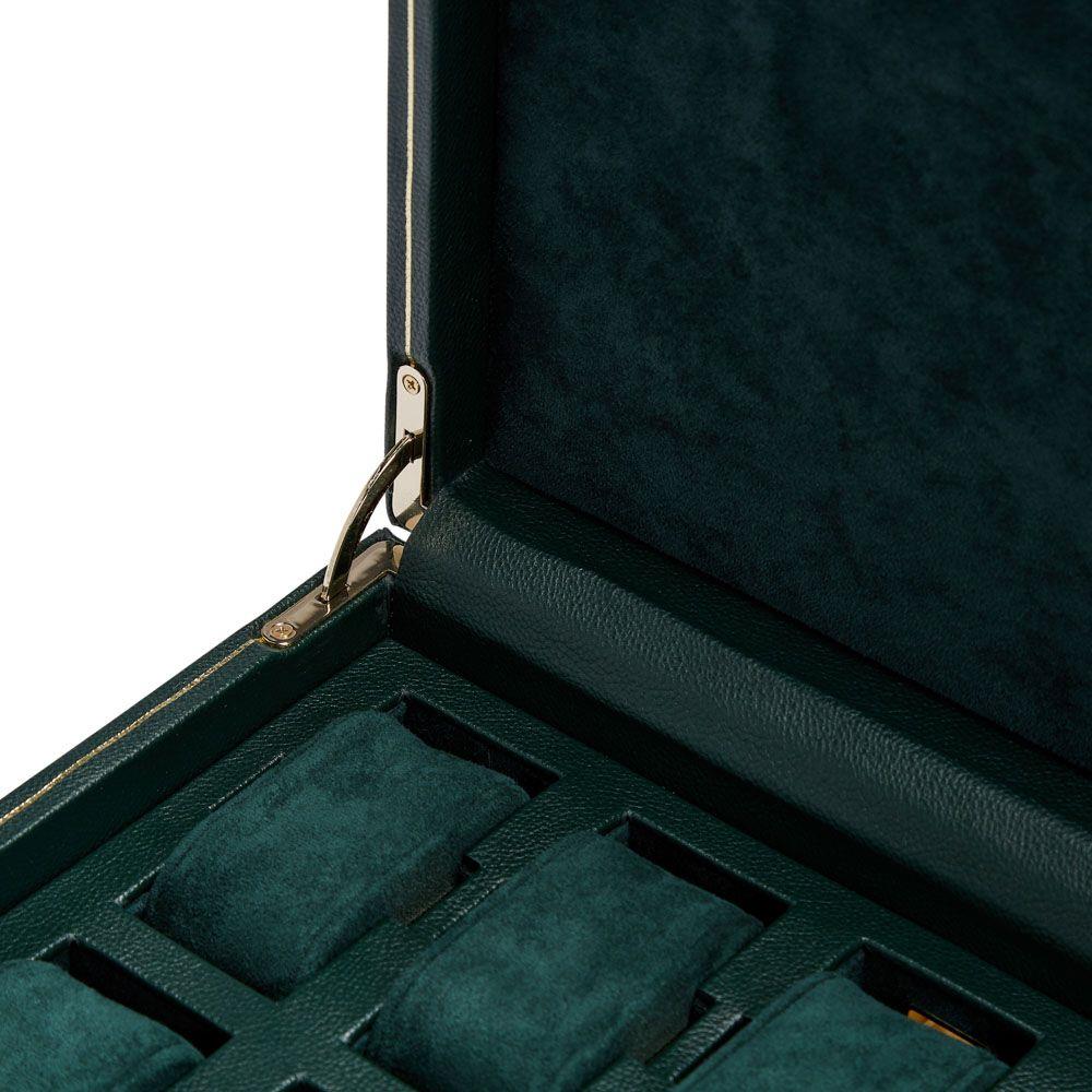 Open green watch box showing padded interior slots and lid support hardware
