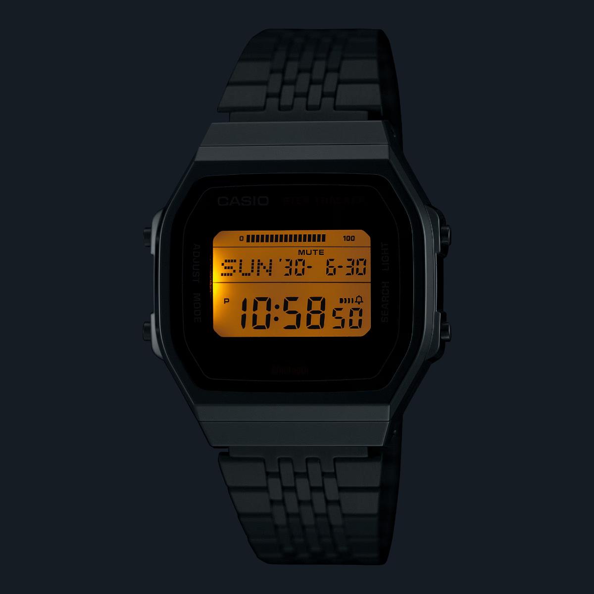 Casio digital watch with black metal bracelet and illuminated LCD display