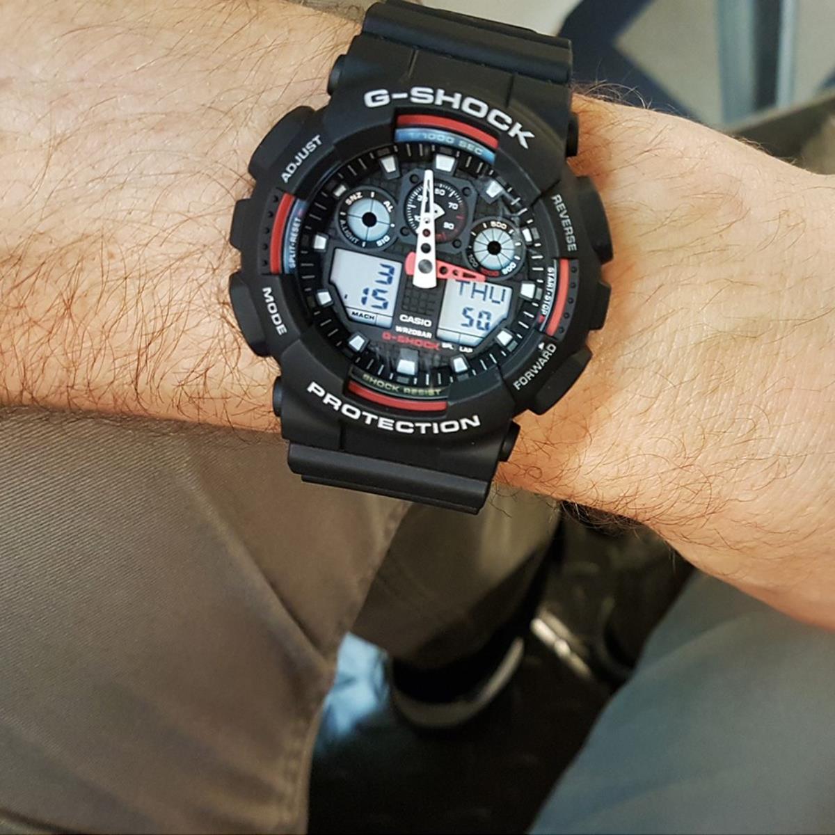 Casio G-Shock GA-100-1A4ER close-up lifestyle view showing black dial watch on wrist