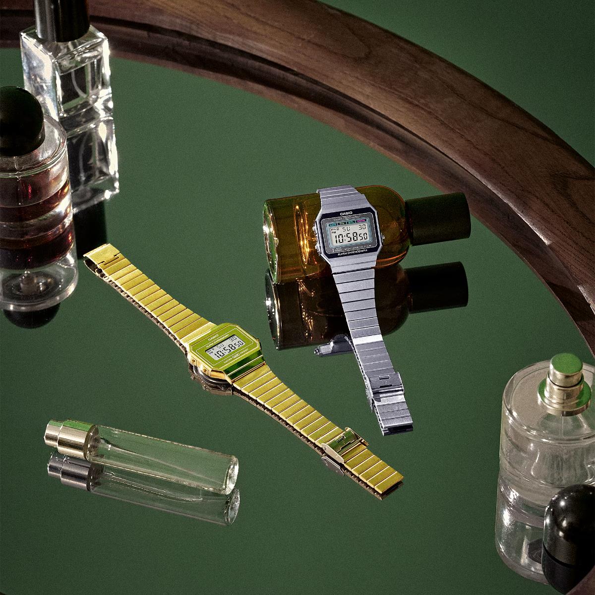 Casio Vintage Iconic A700WEVG-9AEF gold and silver digital steel strap watches on reflective surface