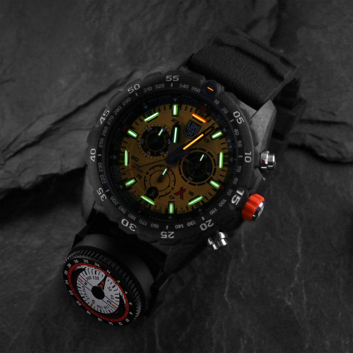 Men's sport watch with yellow dial, green lume, black rubber strap, and orange crown