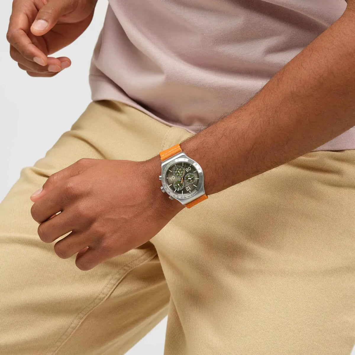 Textile strap watch with silver case and brown multi-dial face, orange strap.