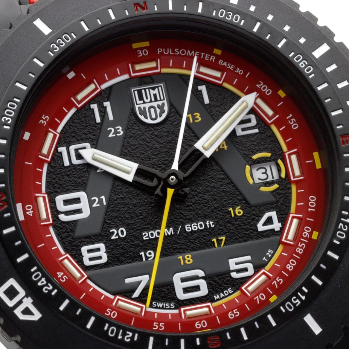 Close-up of the Luminox ICE-SAR watch dial, showing the textured black face, red pulsometer outer ring, white hands, yellow seconds hand, and a date display window