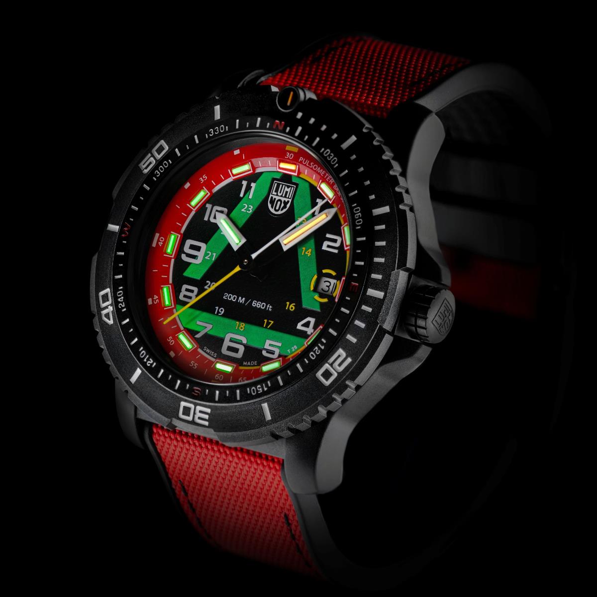 Angled view of Luminox ICE-SAR XL.1095 watch in the dark, showing its glowing green hands, green inner dial pattern, and red luminous hour markers