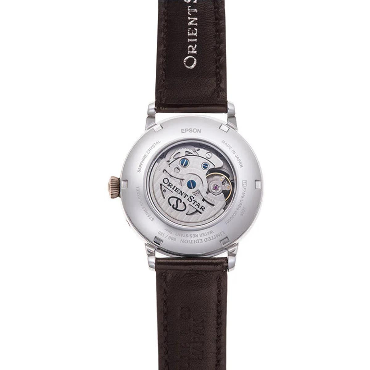 Men's automatic watch case back with visible movement and brown leather strap