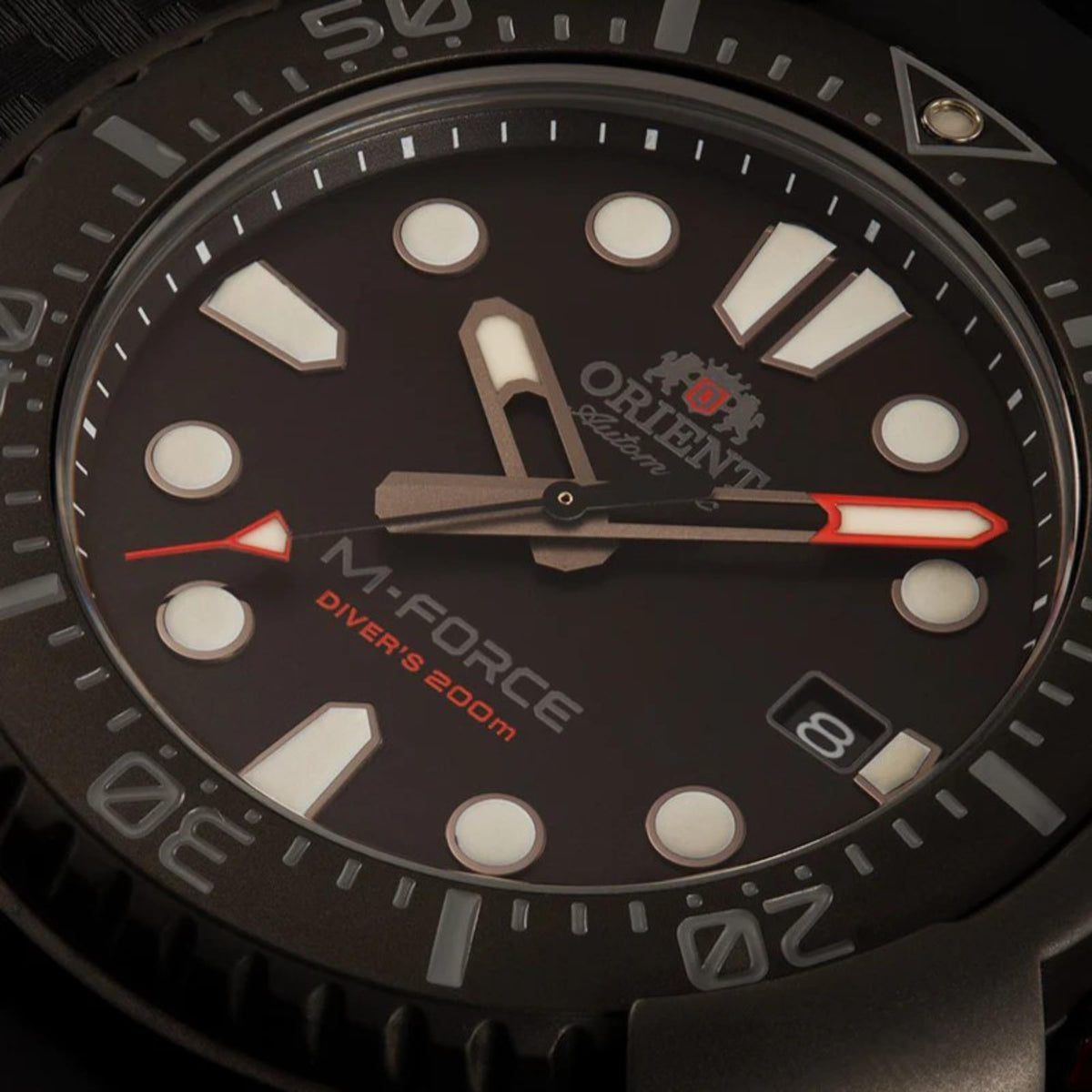 Orient M-Force automatic diver watch with black dial, red accents, and black silicone strap