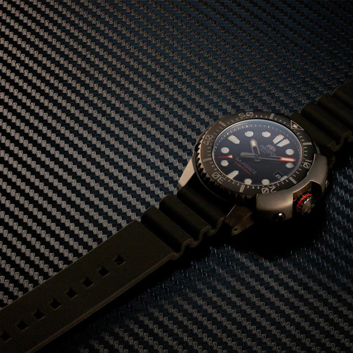 Orient M-Force automatic watch on black silicone strap with dark dial and rotating bezel