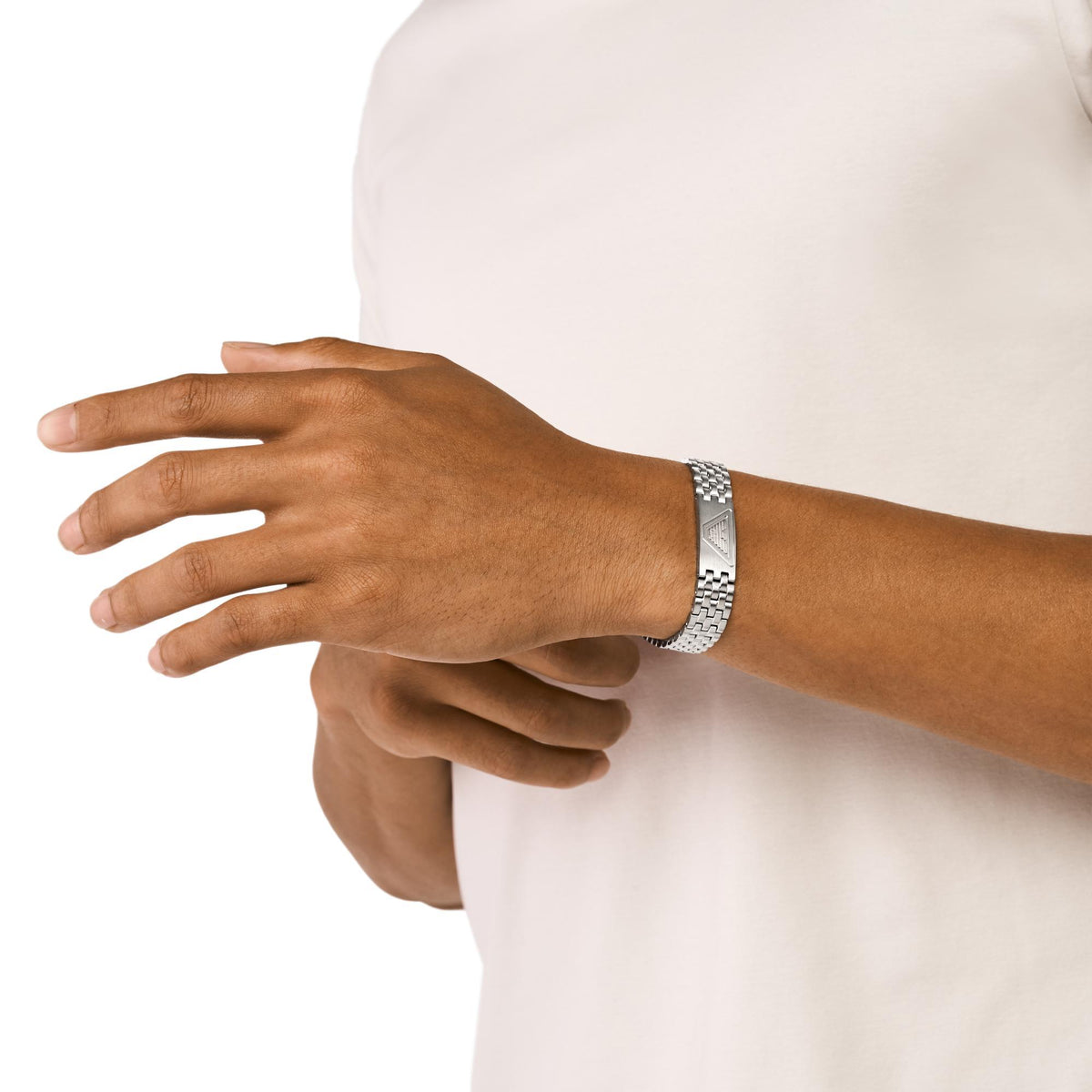 Model wearing Emporio Armani men's silver-tone stainless steel ID bracelet EGS3126040 on wrist