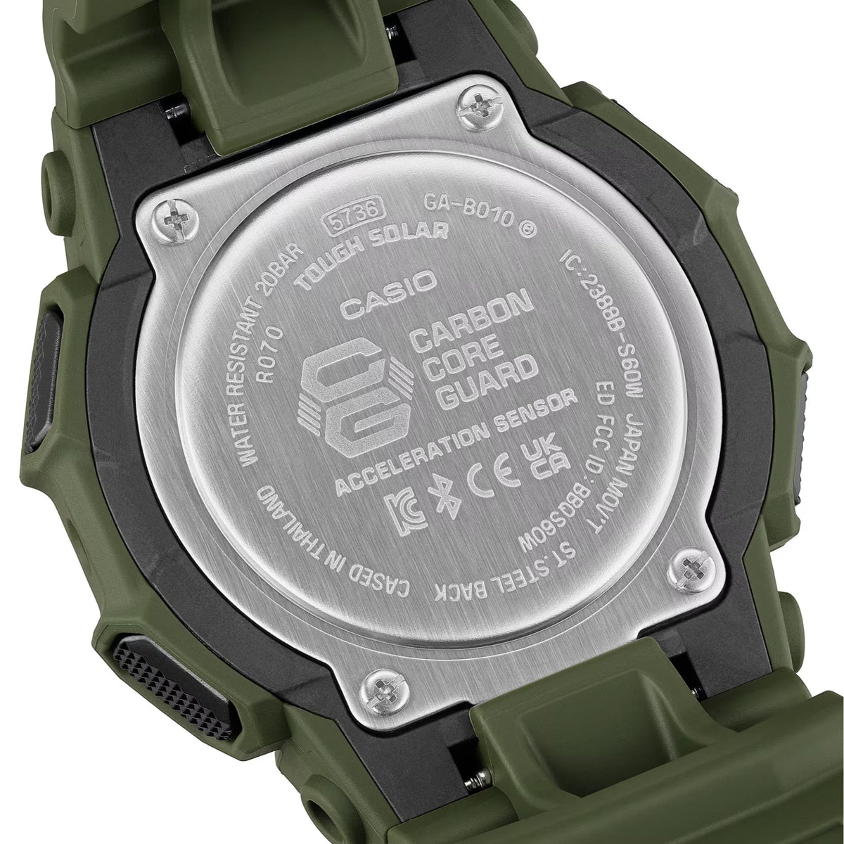 Back of green resin G-Shock watch with metal case markings and screws