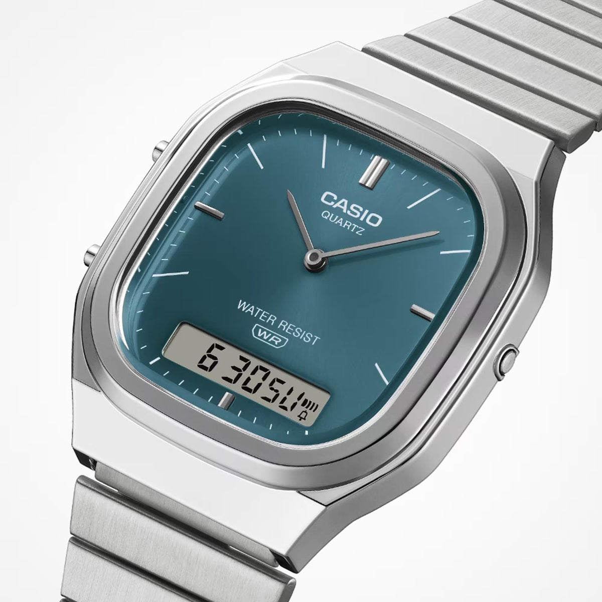 Casio angled watch with teal dial, analog hands, digital time, and WATER RESIST WR