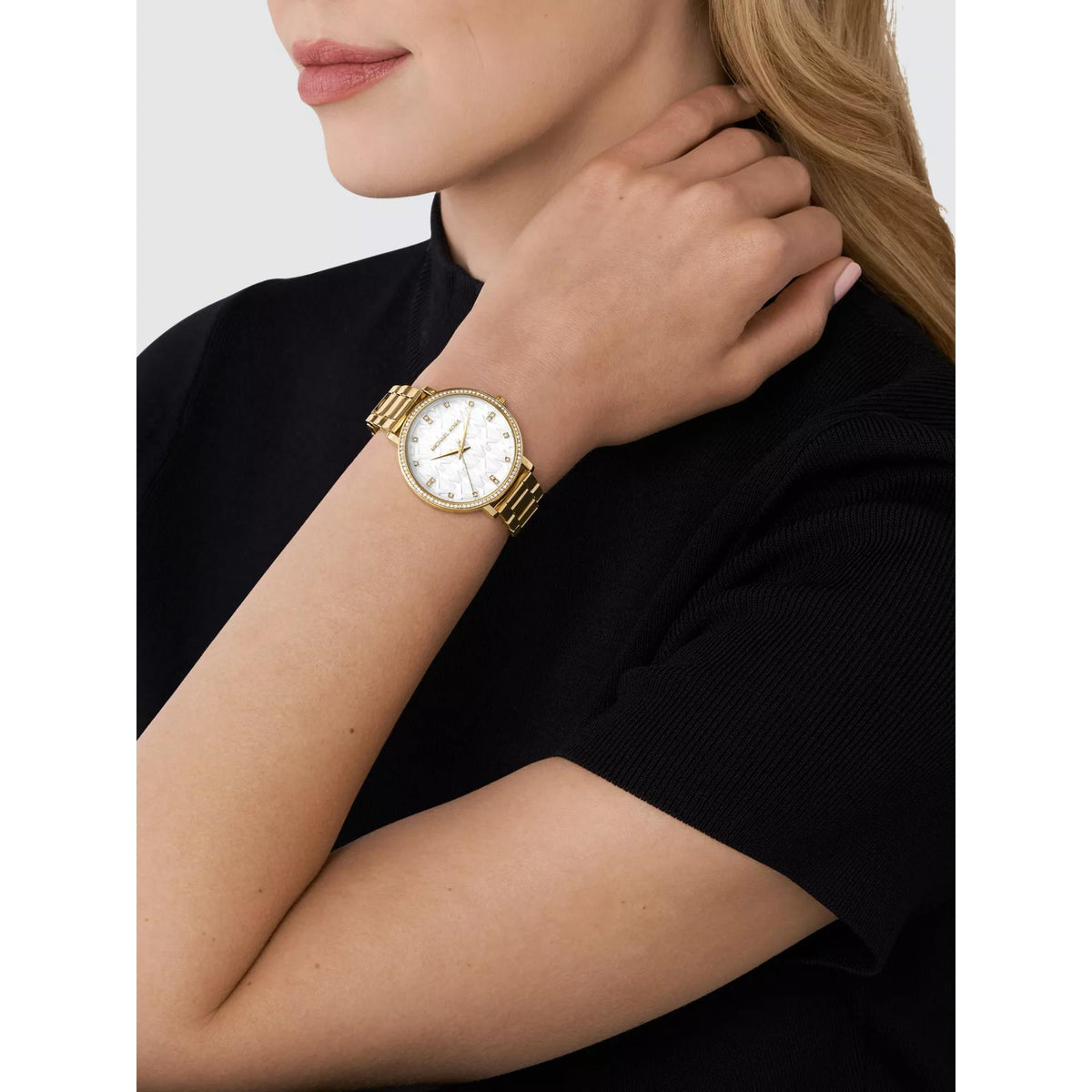 Michael Kors Pyper ladies watch on wrist, gold-tone case and link bracelet, white dial