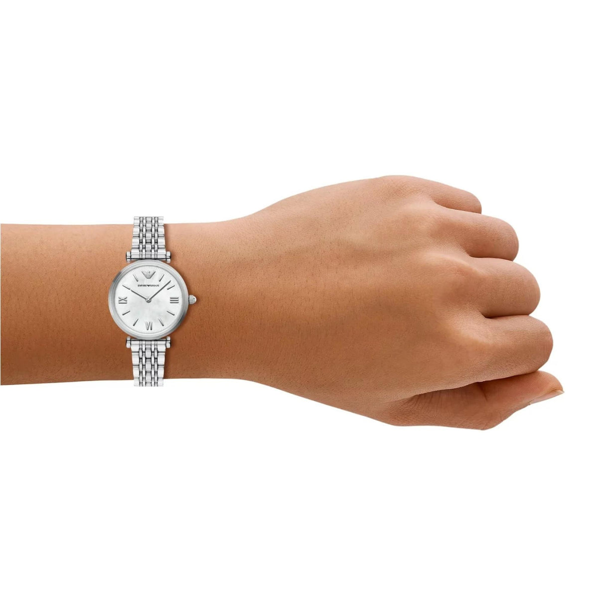 Womens stainless steel watch with white mother-of-pearl dial on a wrist