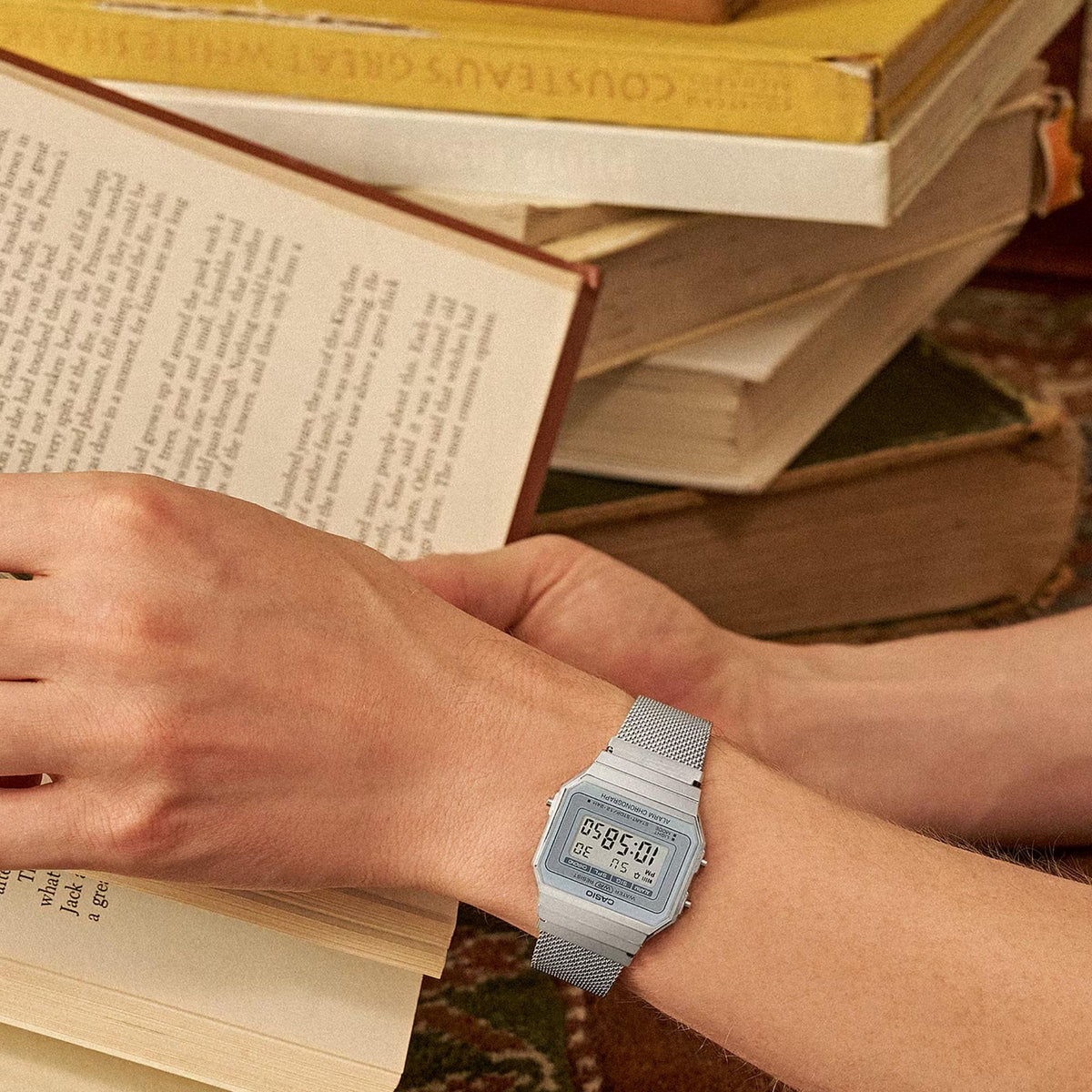 Casio Vintage Mini A700WEM-7AEF lifestyle view on wrist reading a book