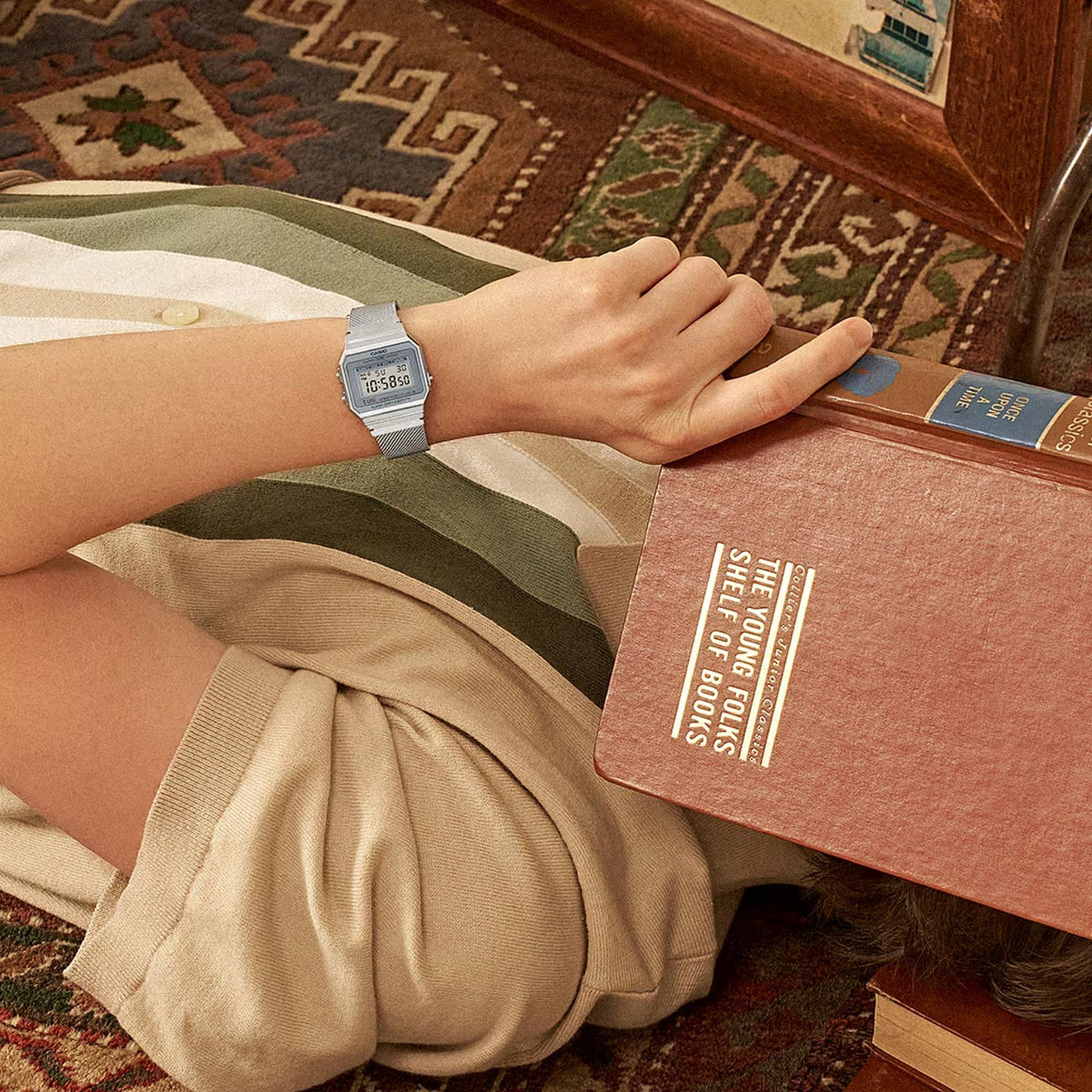 Casio Vintage Mini A700WEM-7AEF lifestyle view on wrist relaxing with books