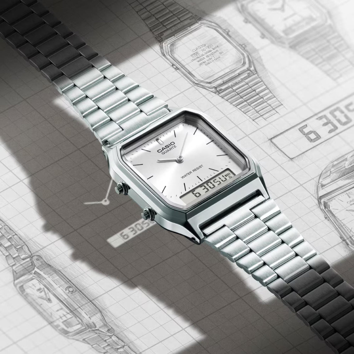 Casio silver steel quartz wrist watch, white dial with digital display, metal bracelet