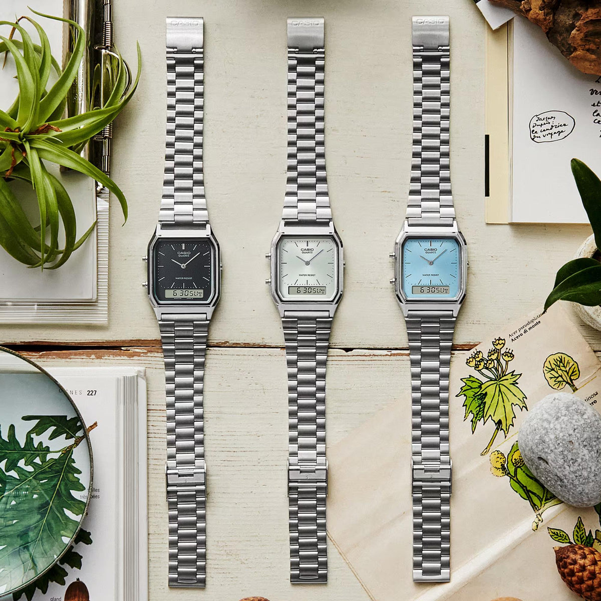 Silver steel quartz wrist watch set with white, blue, and dark dials, metal bracelets
