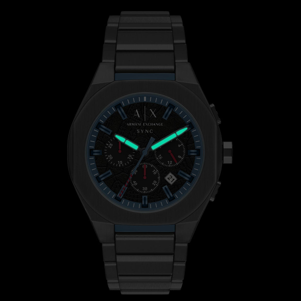 Armani Exchange Sync AX4295 mens quartz watch with luminous blue hands and markers glowing in darkness