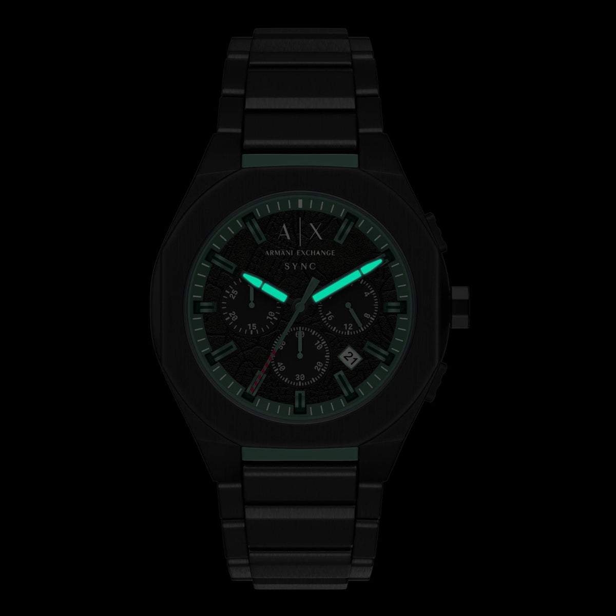 Armani Exchange Sync AX4294 mens quartz watch with luminous green hands and markers in low light
