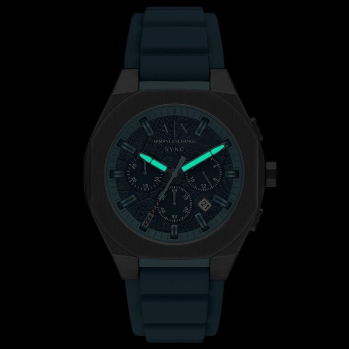 Armani Exchange Sync AX4291 mens quartz watch with luminous glowing hands and markers in low light