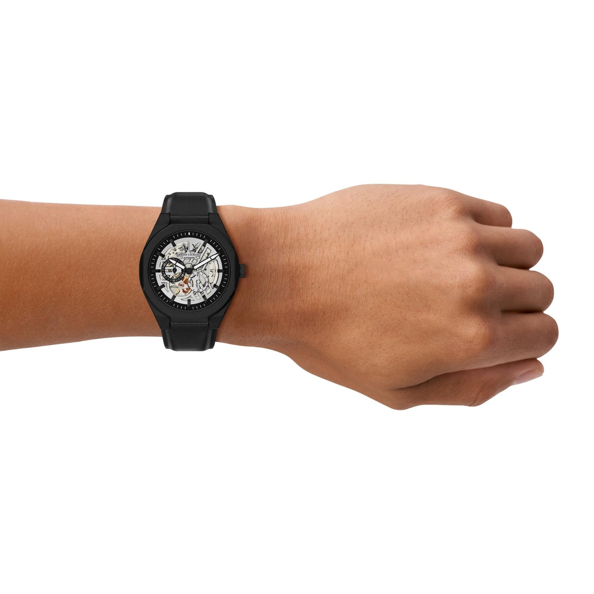 Armani Exchange Sync black skeleton watch worn on wrist showcasing comfortable black leather strap and open dial