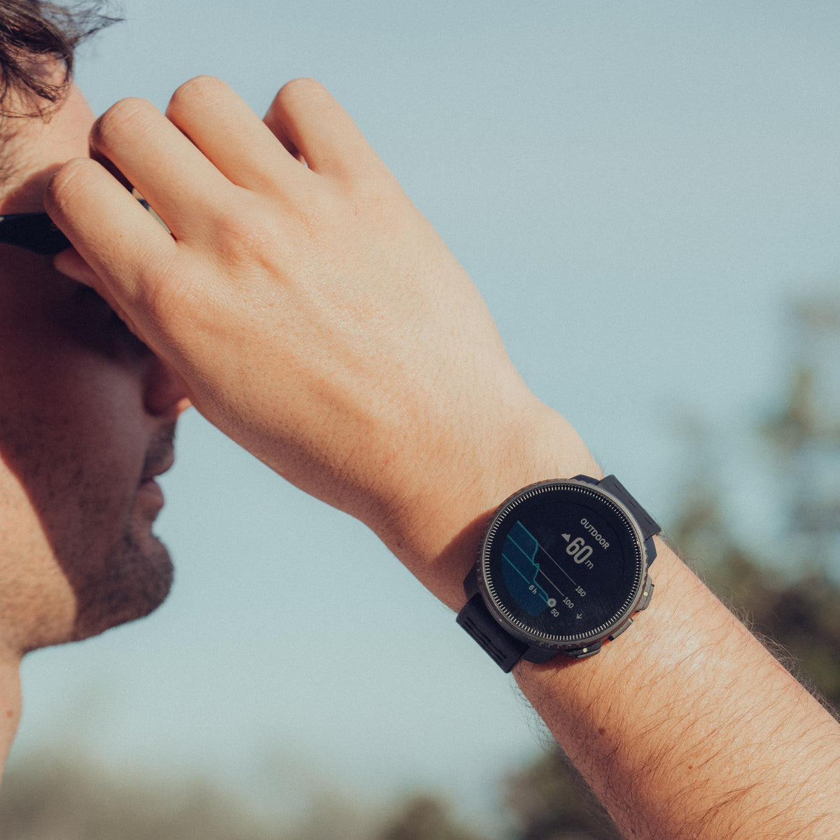 Suunto Vertical SS050862000 All Black Digital Silicone Smart Watch worn on wrist outdoors displaying altitude widget