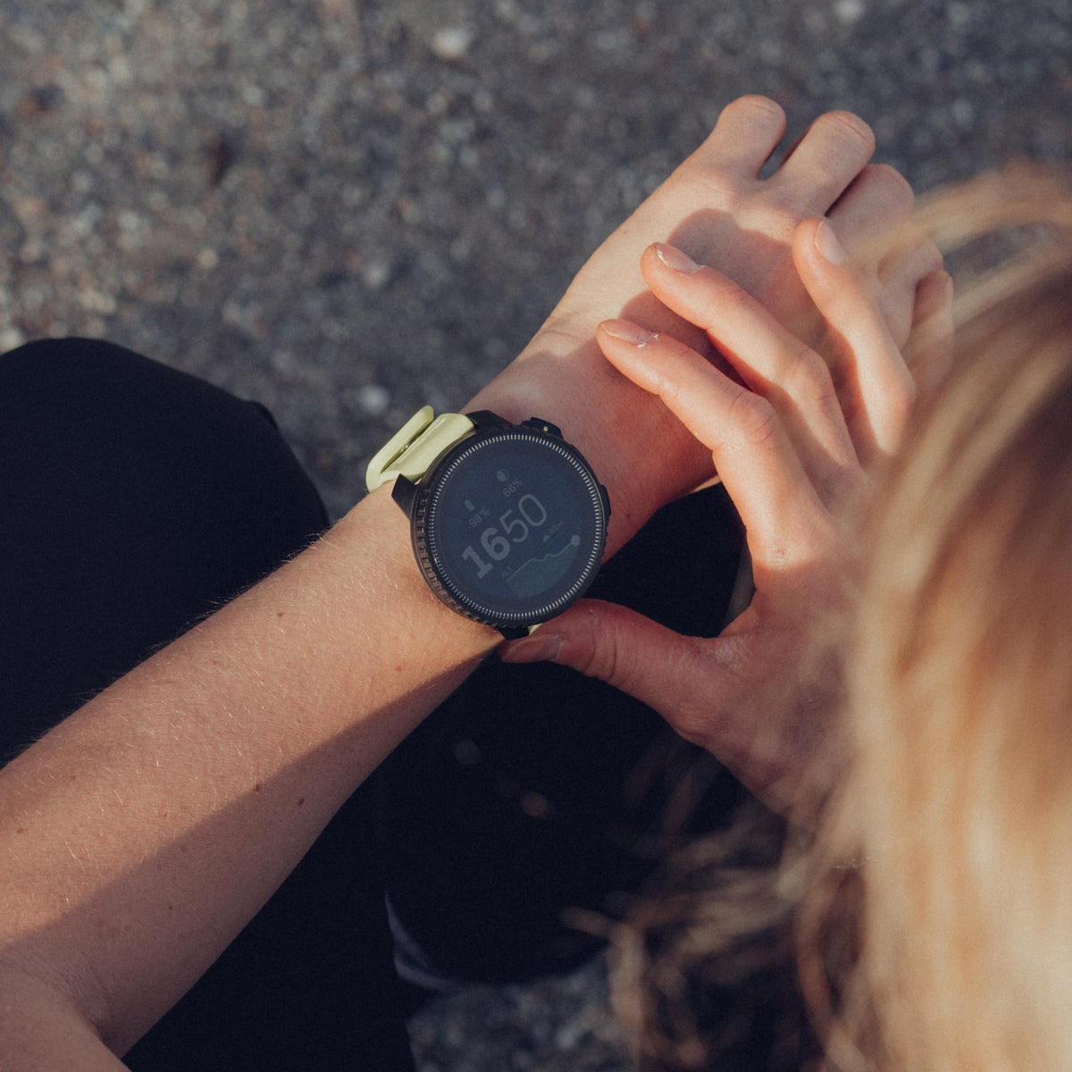 Suunto Vertical Black Lime SS050864000 lifestyle view worn on wrist outdoors showing digital face