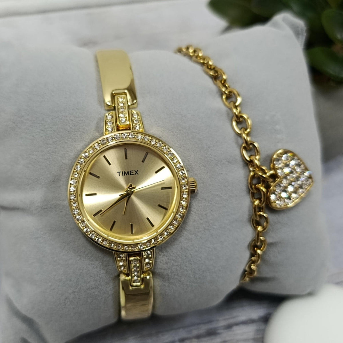 Timex gold-tone ladies quartz wristwatch TWG067900 with gold dial, crystal bezel, and heart pendant bracelet