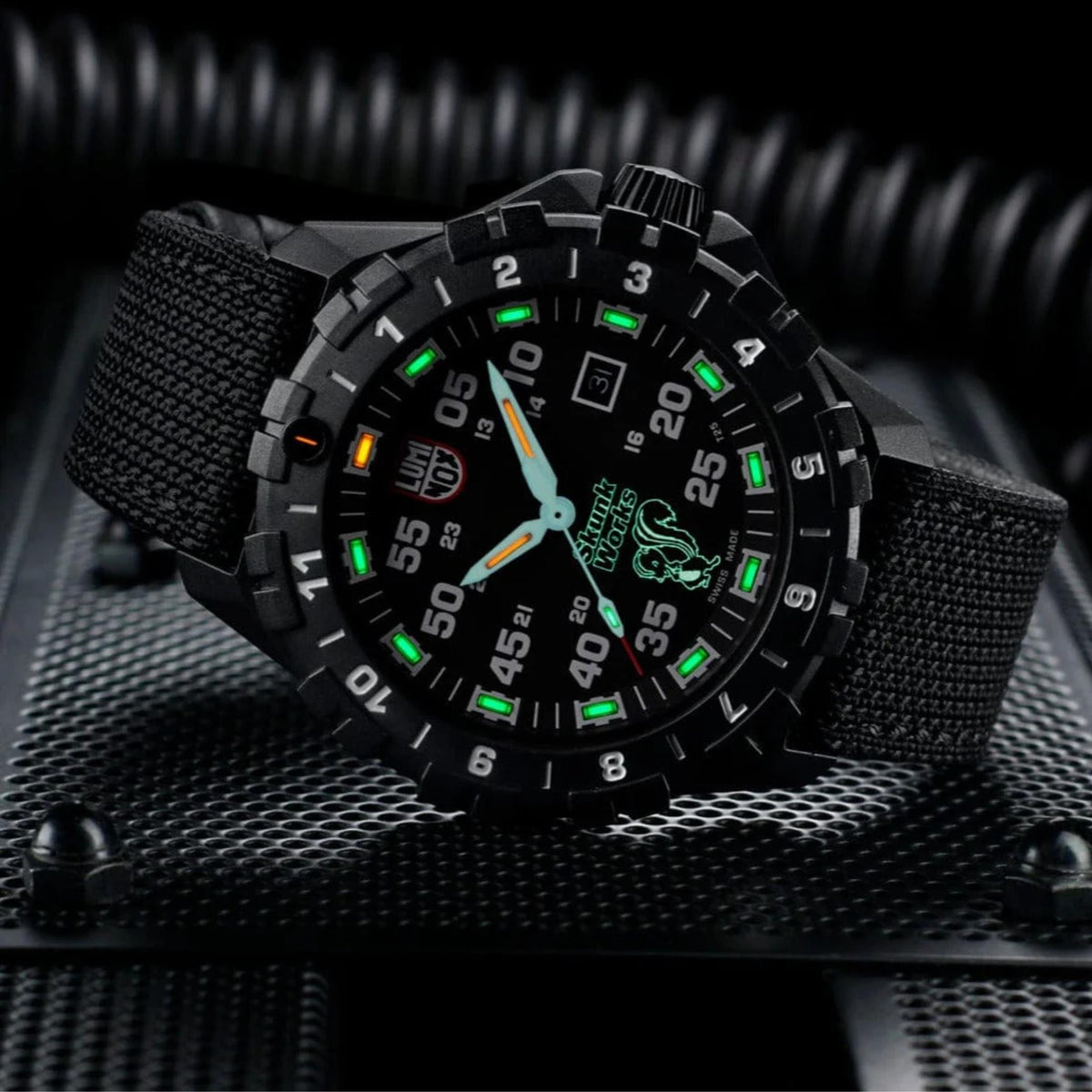Illuminated green and orange tritium night tubes glowing on the Luminox F-117 Nighthawk XA.6442.H dial in low light