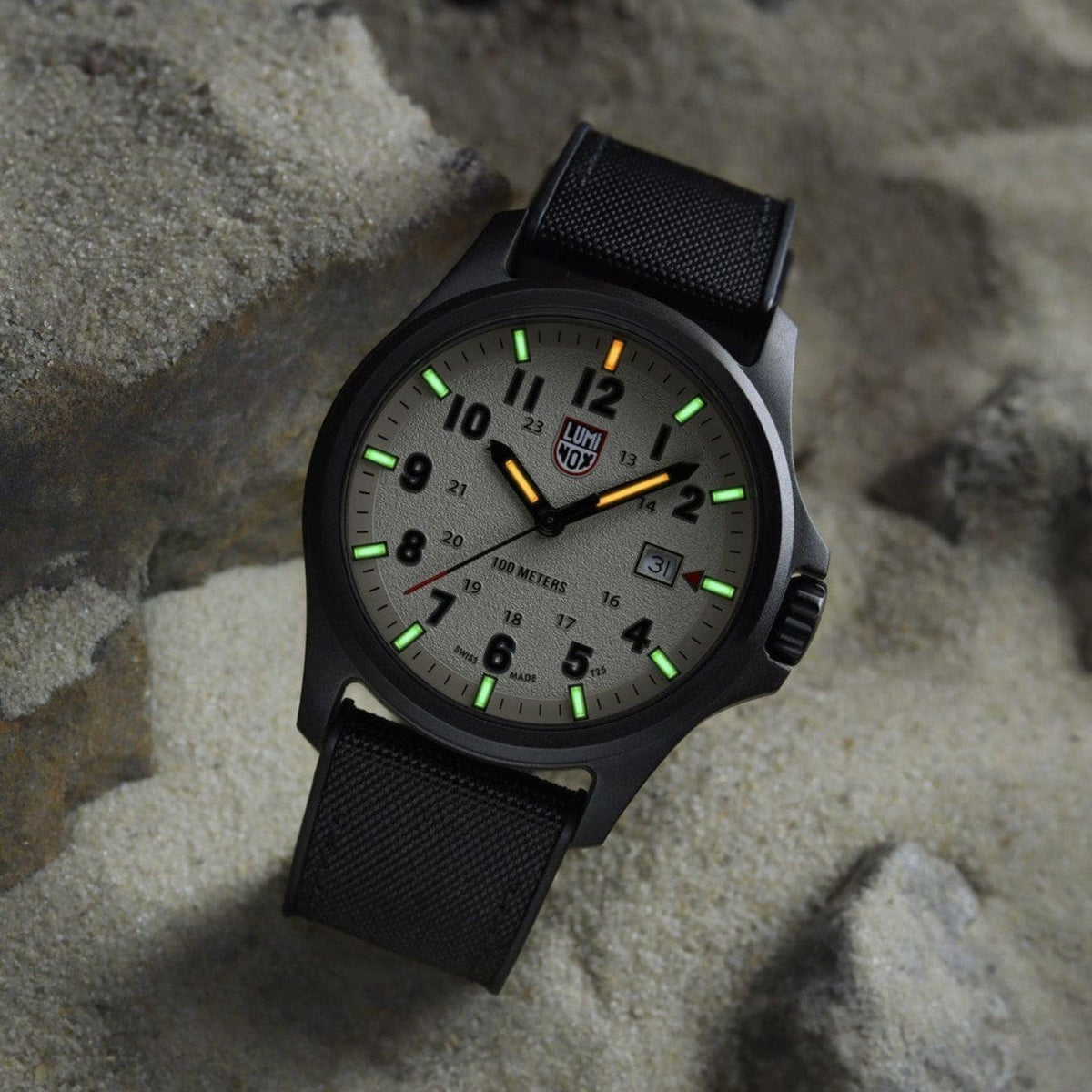 Men's grey dial field watch with black rubber strap and glowing green hour markers
